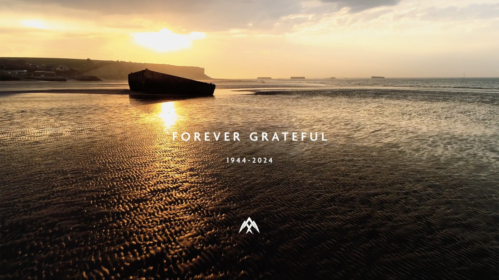The image shows Gold Beach in Normandy at sunset - main landing site of the British forces on D-Day. Overlaid to the centre of the image are the words 'Forever grateful', with the dates 1944 - 2024 below. In the lower part of the image is the AERALIS logo in white.